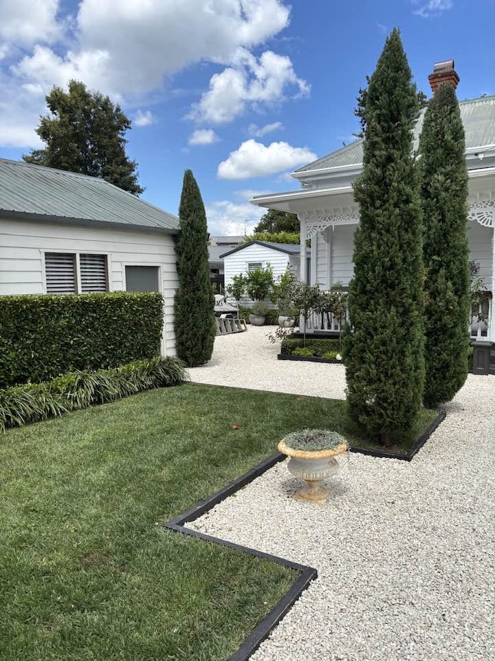 Villa frontage with clipped hedging and gravel drive